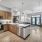 Open kitchen with stainless steel package, quartz counter tops, and under cabinet lighting