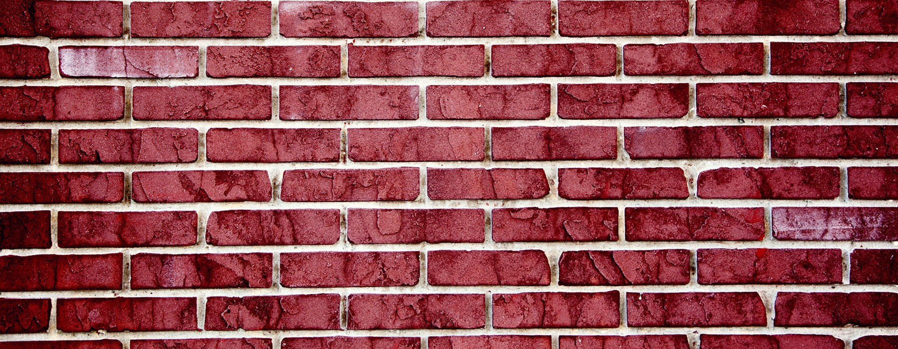 red brick wall with white grouting